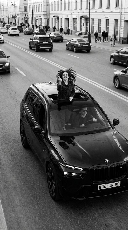 пара в черном bmw x7 с кадром из люка